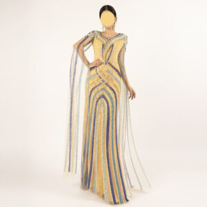 Crafted for the woman who commands attention, this gold mermaid evening gown marries Middle Eastern opulence with red-carpet glamour. The V-neckline frames your collarbone with subtle elegance, while sheer tulle cape sleeves drape gracefully from the shoulders, adding weightless movement to every step. Intricate geometric beadwork in gold, deep blue, and turquoise wraps the entire silhouette, catching light to create a shimmering, multi-dimensional effect. The form-fitting mermaid cut hugs your curves before flaring at the hem, ensuring a statuesque, unforgettable look for weddings, galas, or any milestone event.