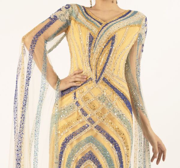 Elevate your formal wardrobe with this gold mermaid evening gown, featuring eye-catching geometric beading and sheer cape sleeves. The V-neck design flatters the neckline, while the form-fitting skirt enhances your curves for a statuesque look. The sheer tulle sleeves add drama and movement, and the intricate blue and gold beadwork ensures you’ll stand out at any wedding, gala, or special event. Lightweight yet structured, this gown balances elegance and allure perfectly.