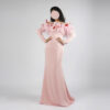 Pink off-the-shoulder mermaid evening gown with pink feather trim and red petal accents, long sleeves, floor-length satin dress