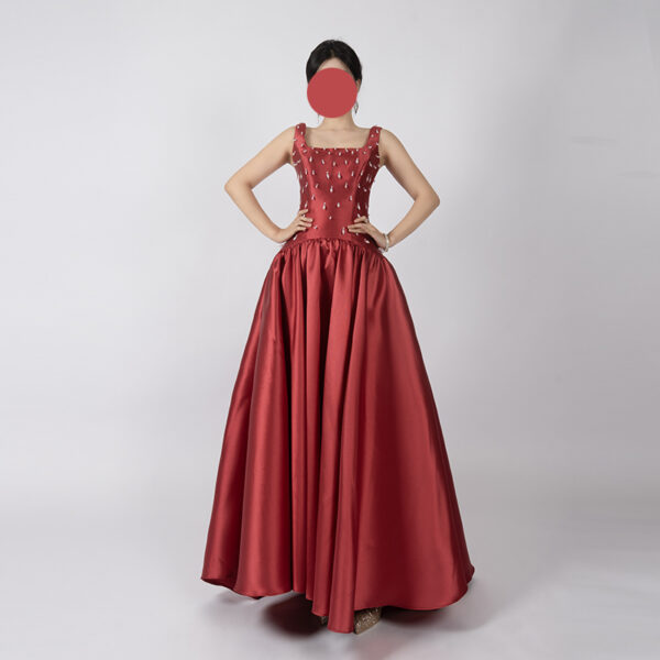 Elegant burgundy satin ball gown with square neckline, beaded bodice, and voluminous floor-length skirt, ideal for formal events and weddings.