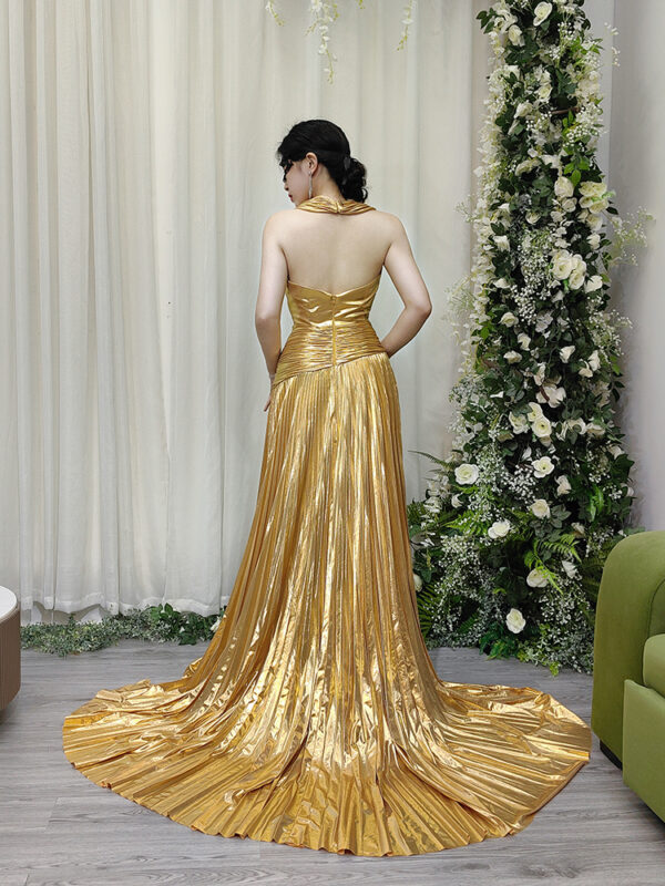 Elegant gold pleated evening dress with sleeveless deep V-neck, high slit, and dramatic trailing train.