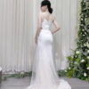 Elegant white tulle mermaid evening dress with sheer neckline, side cutouts, and crystal embellishments.