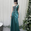 Emerald green one-shoulder satin mermaid gown with beaded bodice, high slit, and trailing train, styled with a lace mask and beaded clutch.