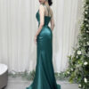 Luxury emerald green mermaid gown with beaded one-shoulder bodice and satin skirt with high slit.