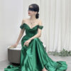 Luxury emerald green mermaid gown with off-the-shoulder glitter neckline, corset bodice, and satin skirt with high slit.