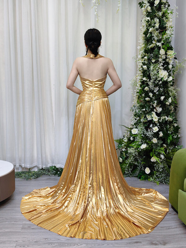 Luxury gold lamé pleated formal dress with sleeveless deep V-neck, high slit, and trailing train.