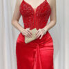 Luxury red beaded corset gown with satin mermaid skirt and trailing train.