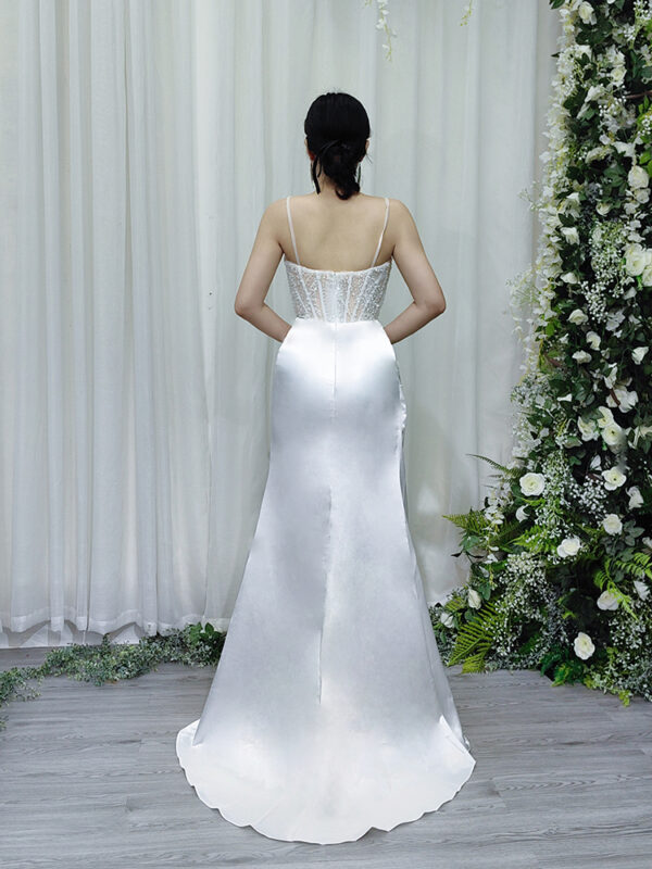 Luxury white beaded corset gown with satin mermaid skirt and trailing train.