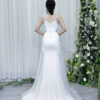 Luxury white crystal-embellished mermaid gown with sheer neckline and side mesh cutouts.