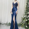 Navy blue mermaid gown with beaded sheer bodice, satin skirt, high slit, and trailing train, styled with a lace mask and beaded clutch.
