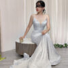 Romantic pale blue glitter mermaid gown with spaghetti straps and deep V-neck, paired with a lace mask and beaded clutch.