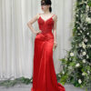 Stunning red beaded spaghetti strap mermaid gown with satin skirt and trailing train, worn with a lace mask and beaded clutch.