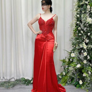 Stunning red beaded spaghetti strap mermaid gown with satin skirt and trailing train, worn with a lace mask and beaded clutch.