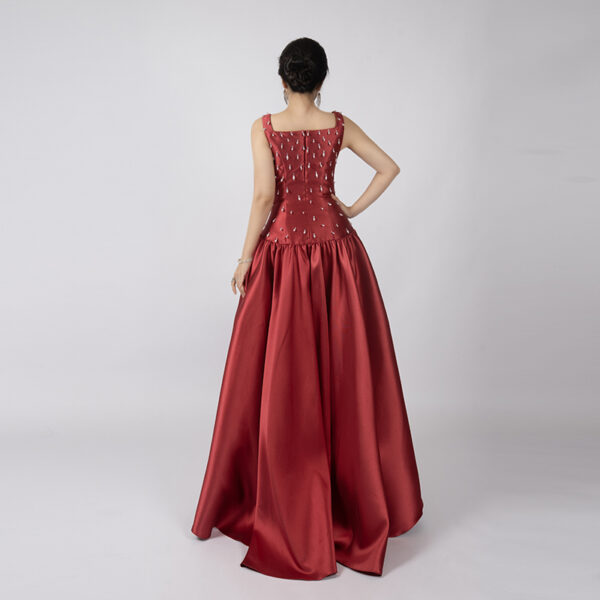 Romantic deep red satin ball gown with square neckline, beaded bodice, and full floor-length skirt, wedding guest or bridal formal wear.