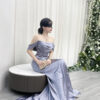 Romantic dusty blue satin mermaid wedding guest gown with off-the-shoulder design.