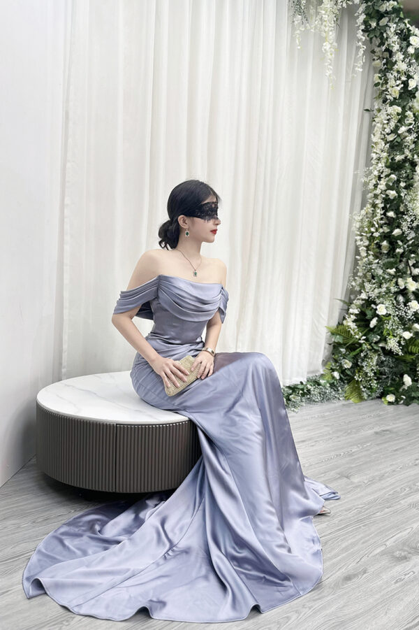 Romantic dusty blue satin mermaid wedding guest gown with off-the-shoulder design.