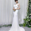 White mermaid wedding gown with sheer beaded neckline, side cutouts, and sparkling tulle skirt with train.