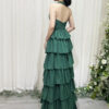 Elegant emerald green halter-neck ruffle maxi dress with glittery texture and floor-sweeping train.
