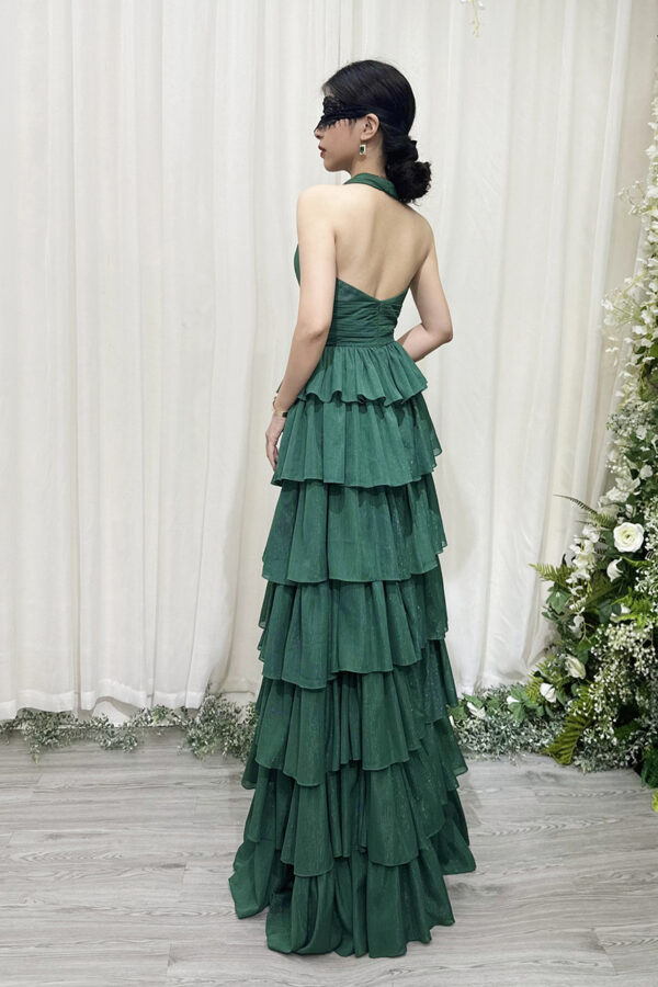 Elegant emerald green halter-neck ruffle maxi dress with glittery texture and floor-sweeping train.