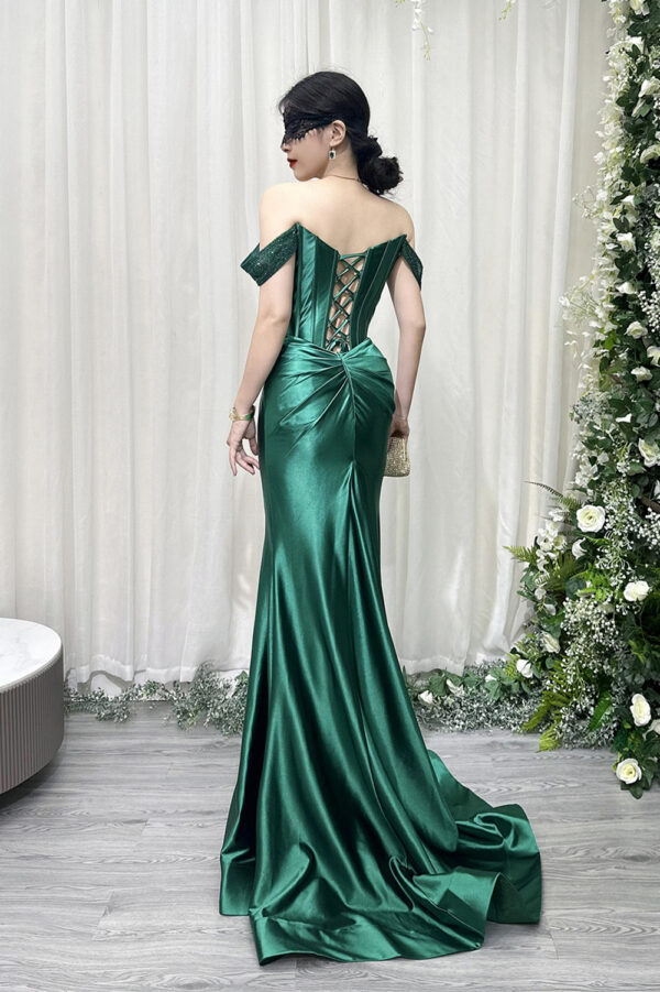 Elegant emerald green satin evening dress with off-the-shoulder neckline, corset bodice, and high side slit.