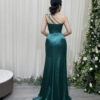Elegant emerald green satin evening dress with one-shoulder beaded bodice and high side slit.