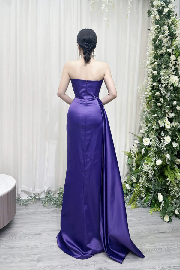 Elegant purple satin strapless evening dress with ruched bodice and high side slit.