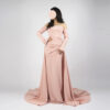 Elegant blush pink off-the-shoulder gown with ruched bodice, long flared sleeves, and trailing train