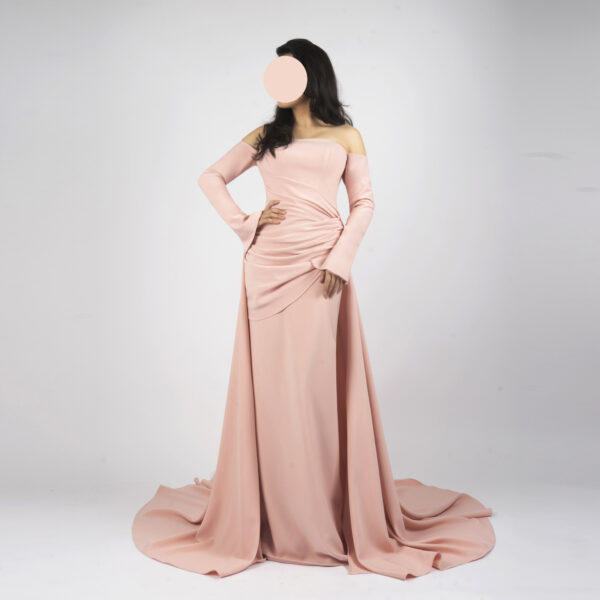 Elegant blush pink off-the-shoulder gown with ruched bodice, long flared sleeves, and trailing train
