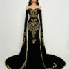 Black velvet evening gown with intricate gold embroidery, off-the-shoulder neckline and long bell sleeves, worn by a Middle Eastern model